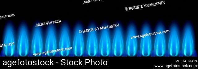 blue gas flames as a banner in front of a dark background