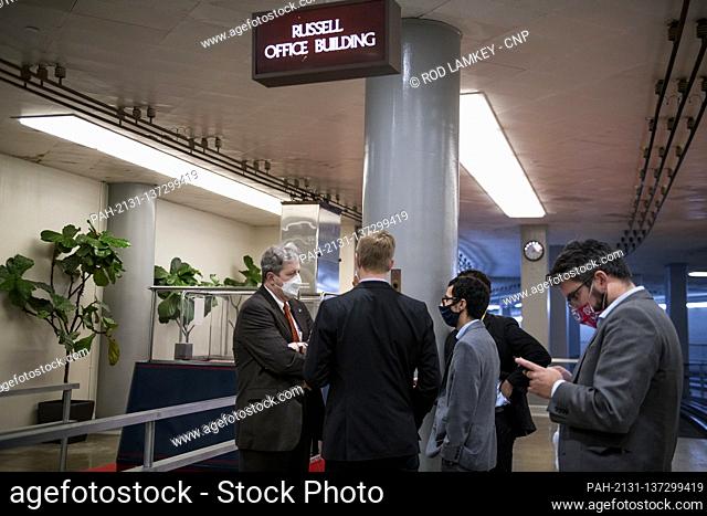 United States Senator John Neely Kennedy (Republican of Louisiana) talks with reporters as he makes his way to a train in the Senate subway following a vote at...
