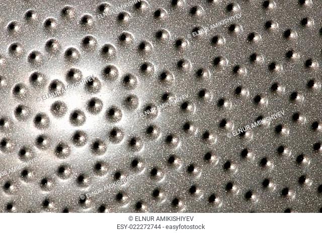 Polished metal surface with the small holes