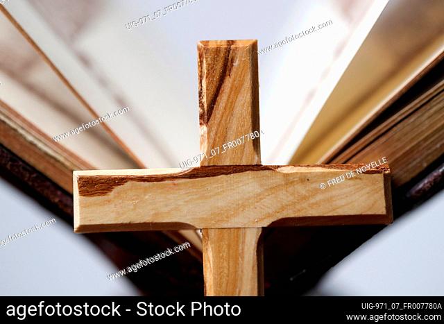 Wooden cross on an open bible. France