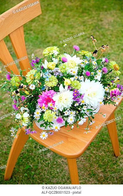 Flower bouquet on wooden chair