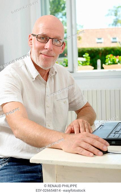 a portrait of a middle age man with laptop
