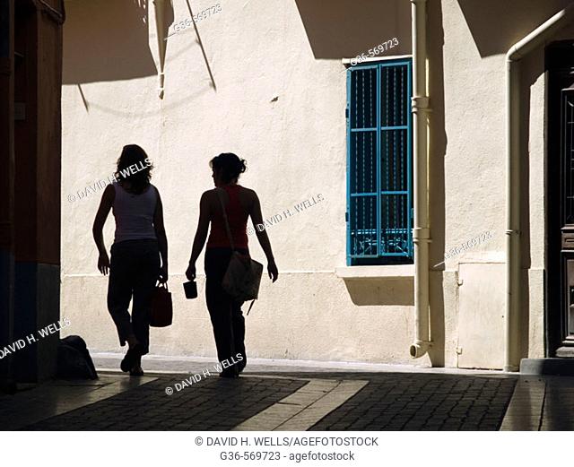 Tourists walk through the sun drenched streets of Colliores, France on the Mediterranean coast