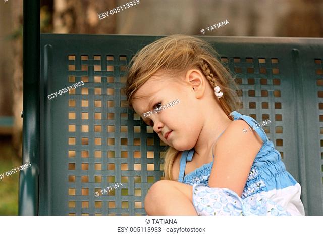sad little child on a bench