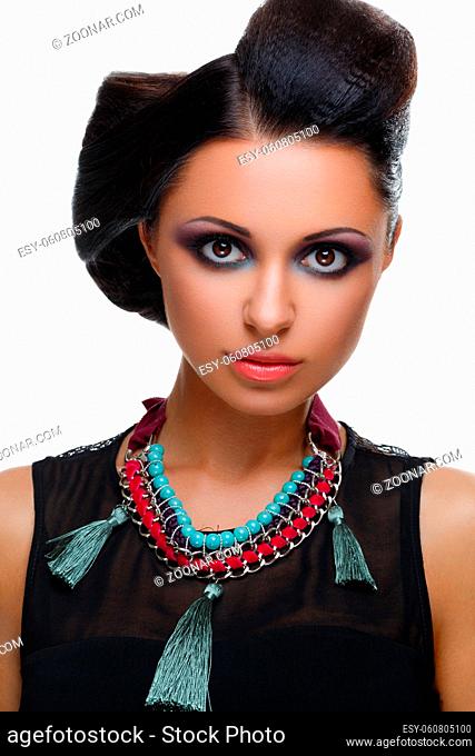 Beautiful young woman with bright purple and green make-up and fancy hairdo. Beauty shot isolated on white background. Copy space