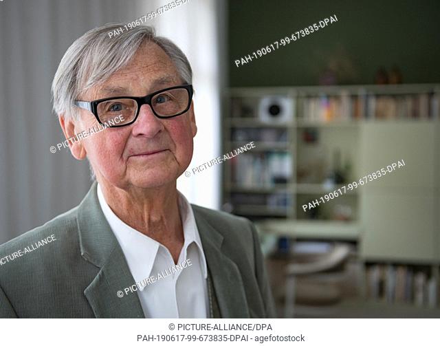 10 May 2019, Saxony, Leipzig: The well-known furniture designer Rudolf Horn stands in his Leipzig apartment in his study before furniture designs from the 1960s...