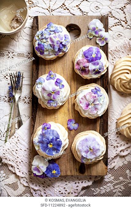 Candied Pansy and Viola Mini Pavlovas on a Wooden Board From Above