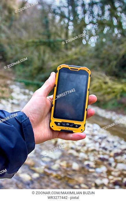 smartphone tracking travel on mountain trails. Phone in hand in a natural walking
