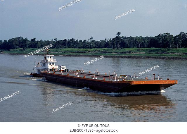 Barge on the Amazon River being pushed upstream towards Manaus