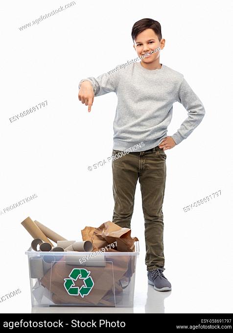 smiling boy sorting paper waste