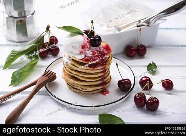 Pancakes with vanilla ice cream, cherry jam and cherries