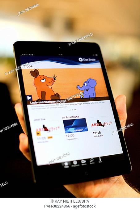 A person presents the ARD app on a tablet computer in Berlin, Germany, 18 March 2013. The new App 'Das Erste' features the current television program of the ARD...