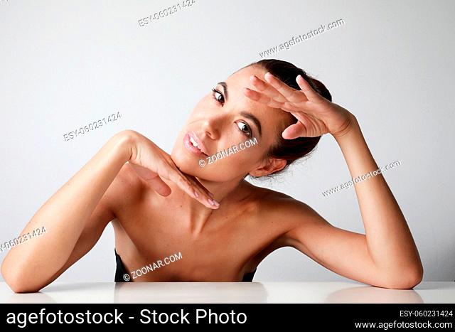 Close-up of attractive middle aged woman touching her cheek skin, mature beauty concept. High quality photo