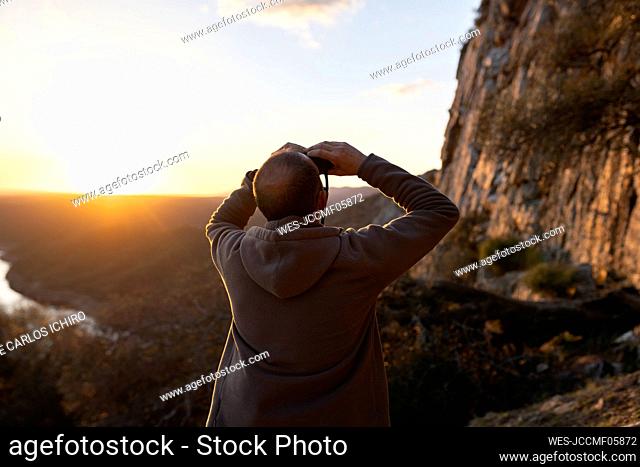 Man bird watching in Monfrague National Park at sunset