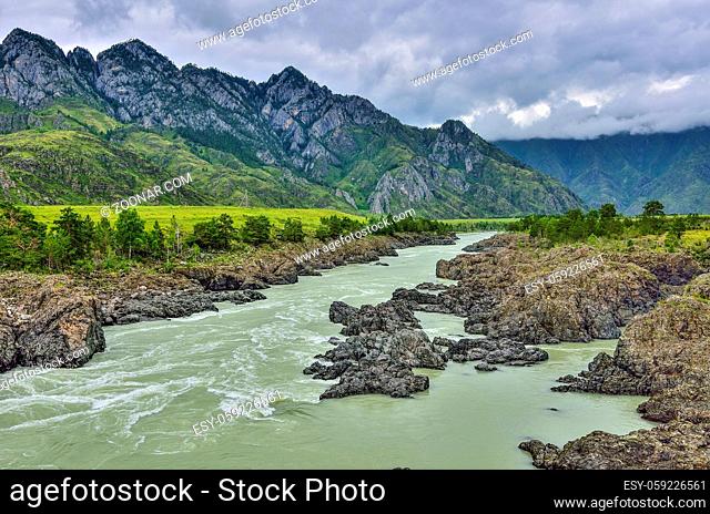 Summer landscape of fast mountain river Katun with Teldykpen rapids near village Oroktoy, Altai mountains, Russia. This is the narrowest and deepest place of...