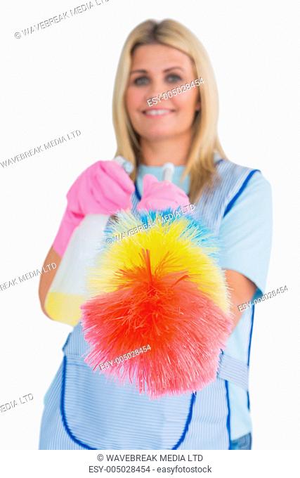 Cleaner holding feather duster in the white background