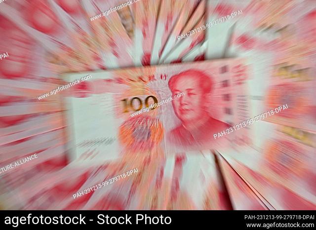 ILLUSTRATION - 12 December 2023, China, Peking: ILLUSTRATION - Several bills, each with a value of 100 Chinese renminbi (yuan), lie on a table