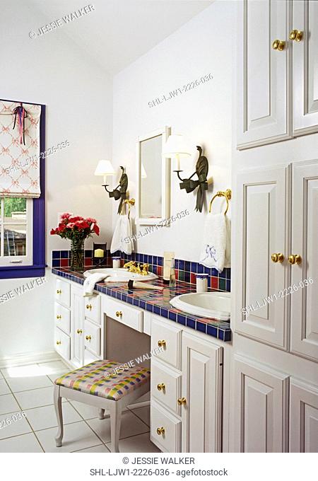BATHROOMS: White bathroom. Double sinks. Blue, raspberry, and green tiles, wall sconces, cobalt painted widow trim, tile floor, shade