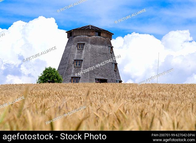 29 June 2020, Brandenburg, Angermünde/Ot Greiffenberg: A windmill without wings is located on a small hill just before entering the village