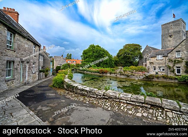 Mill pond, cottages and the Church of St Mary the Virgin on a summer day at Swanage, Dorset, UK