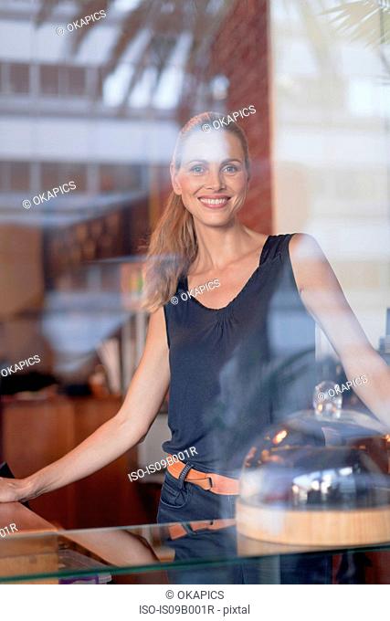 Portrait of mature woman behind counter in cafe