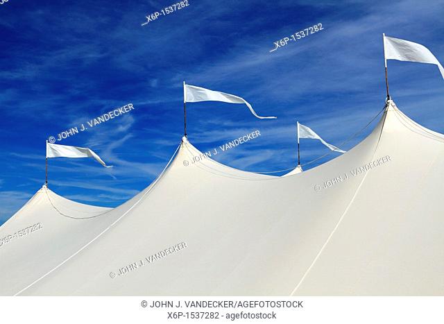 The top of a large white event tent in front of a blue sky  On the beach in Long Branch, New Jersey, USA
