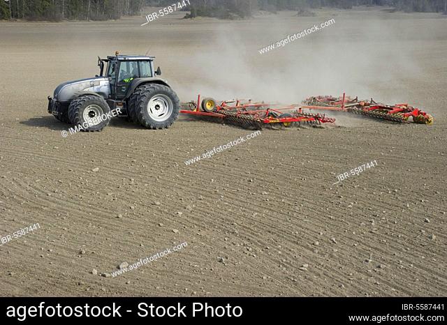 Valtra tractor with Vaderstad NZA-800 and Vaderstad RS-820 harrows and rollers working farmland, Sweden, Europe