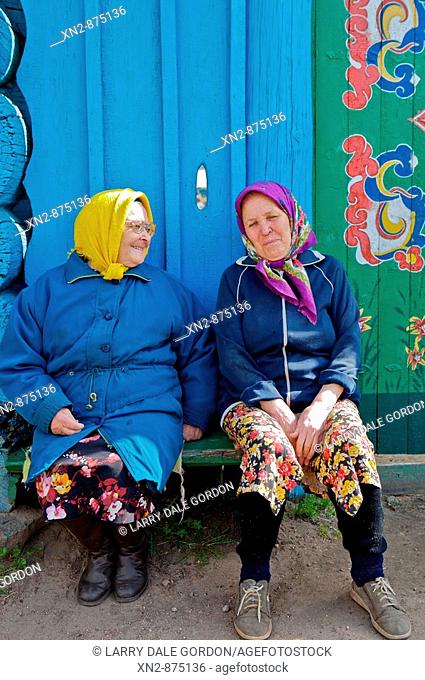 Russia. Tarbagatai Villlage of Old Believers of original Russian Orthodox. Two residents taking the sun