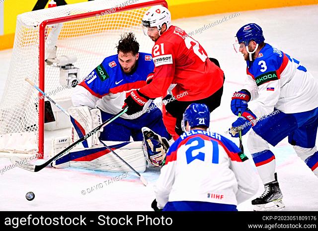 L-R Goalkeeper Samuel Hlavaj (SVK), Kevin Fiala (SUI) and Milos Kelemen and Adam Janosik (both SVK) in action during the IIHF Ice Hockey World Championship