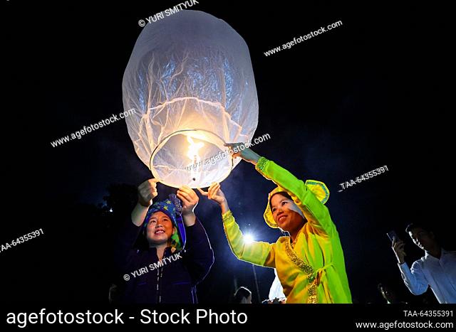 MYANMAR - OCTOBER 27, 2023: Launching paper lanterns during a Phaung Daw Oo pagoda festival on Lake Inle; there are 17 Intha villages along the lake's shores