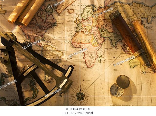 Octant, compass and telescope on nautical map