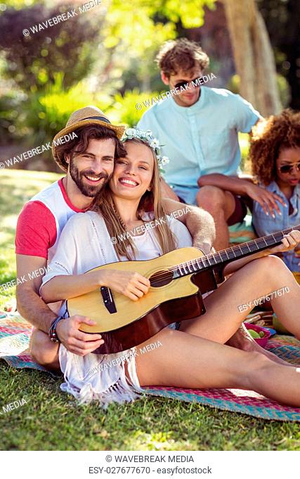 Group of friends having fun and playing music