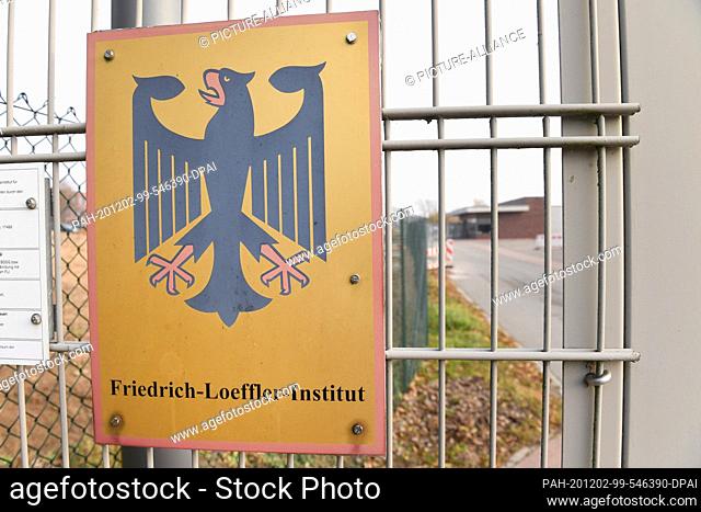 02 December 2020, Mecklenburg-Western Pomerania, Riems: A sign with a federal eagle hangs in the entrance area of the Friedrich-Loeffler-Institute (FLI) for...