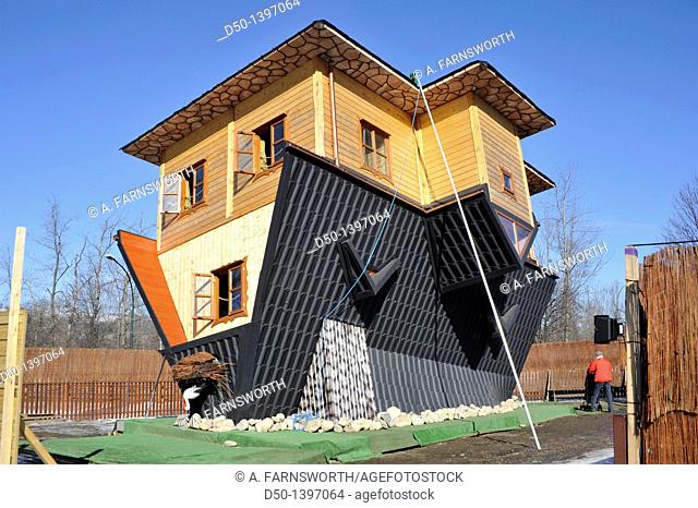 Upside house is used to advertize a new housing complex, Zakopane, Poland