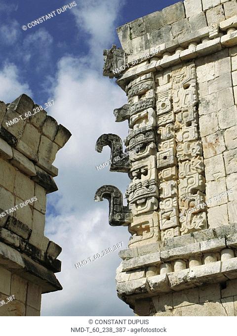 Low angle view of carving on a stone wall, Nunnery Quadrangle, Uxmal, Yucatan, Mexico