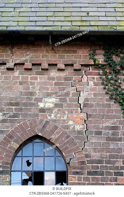 Church building in disrepair with subsidence wall cracks, near Wisbech, Cambridgeshire, UK