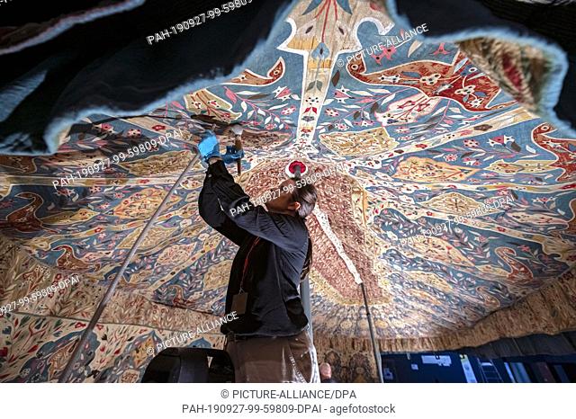 27 September 2019, Baden-Wuerttemberg, Karlsruhe: Agnes Krippendorf, textile restorer at the Badisches Landesmuseum, cleans an Ottoman two-masted tent from the...