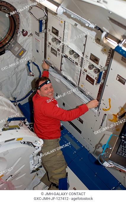 NASA astronaut Ron Garan, Expedition 27 flight engineer, installs a helium valve unit at the Common Gas Supply Equipment (CGSE) rack in the Kibo laboratory of...