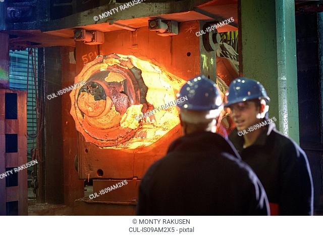 Steelworkers with 10, 000 tonne forging press in steelworks