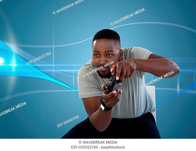 man playing with computer game controller with blue curved background