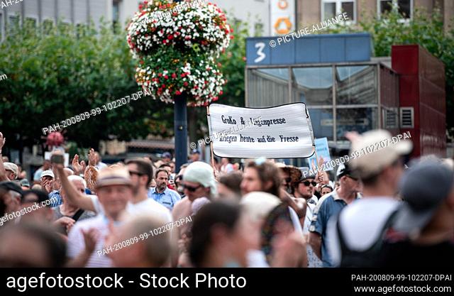 09 August 2020, North Rhine-Westphalia, Dortmund: A participant of the demonstration holds a sign in the air on which ""Groko and Lügenpresse kriegen heute auf...