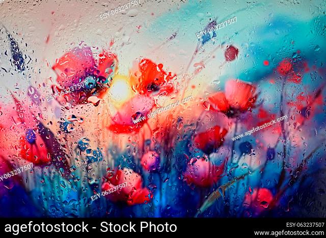 Abstract Red Poppy Fiield Behind Glass Window With Rain Drops