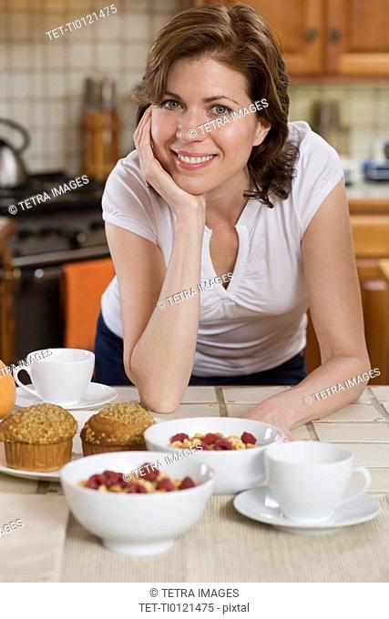 Woman in kitchen with breakfast food