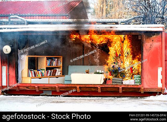 01 December 2023, Berlin: A Christmas tree burns during a demonstration of a fire during the Christmas season on the grounds of the Berlin Fire Academy