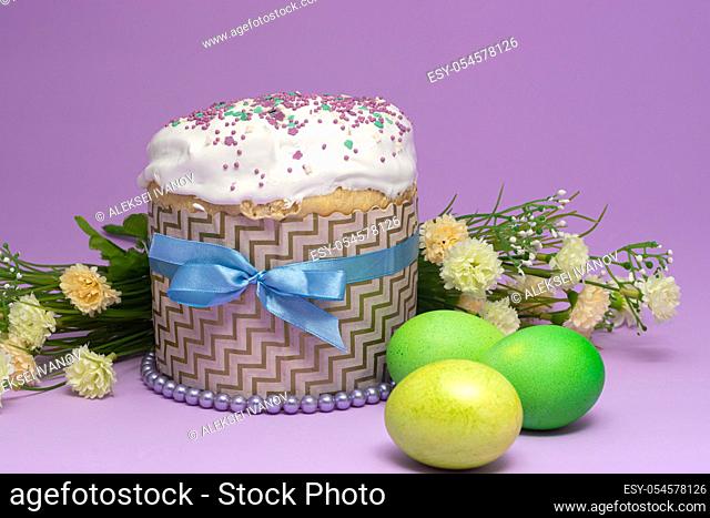 beautifully decorated Easter cake with yellow-green eggs and flowers