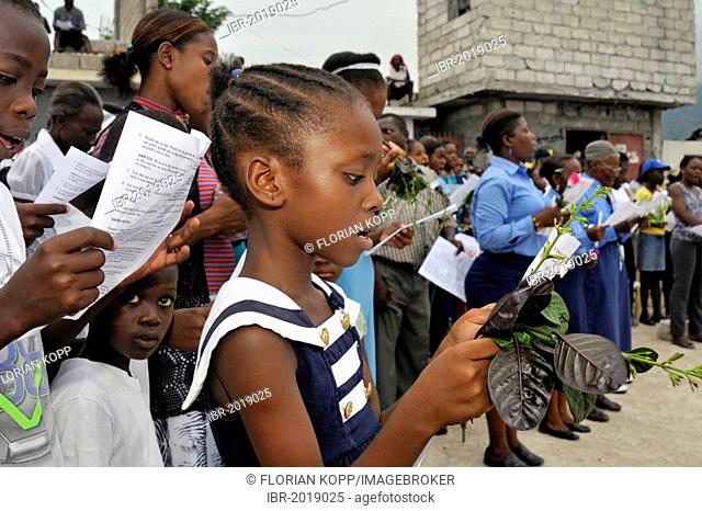 Girl singing during a church service in memory of the victims of the earthquake in January 2010, Fort National district, Port-au-Prince, Haiti, Caribbean