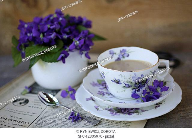 A cup of coffee and violets