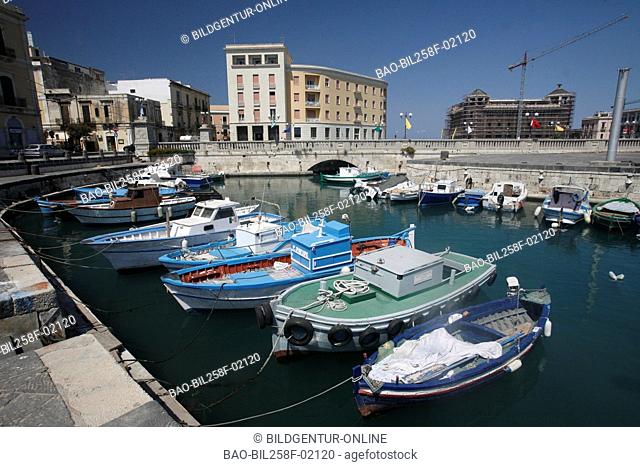 The fishing harbour with the Old Town of Siracusa at the Mediterranean Sea, Italy