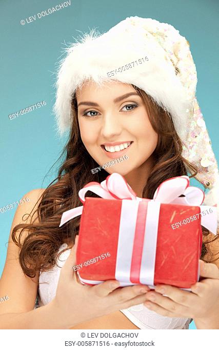 picture of cheerful santa helper girl with gift box.