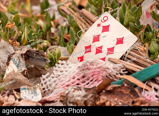 Old playing card on a pile of garbage (Vietnam)